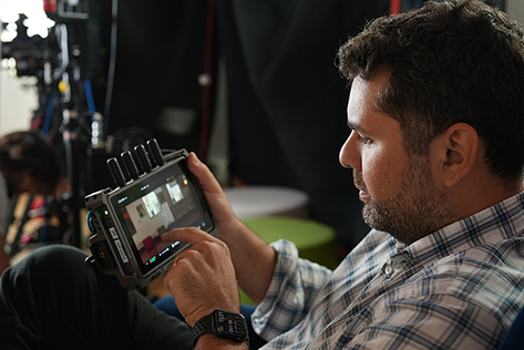 Man holding and using a handheld monitor device