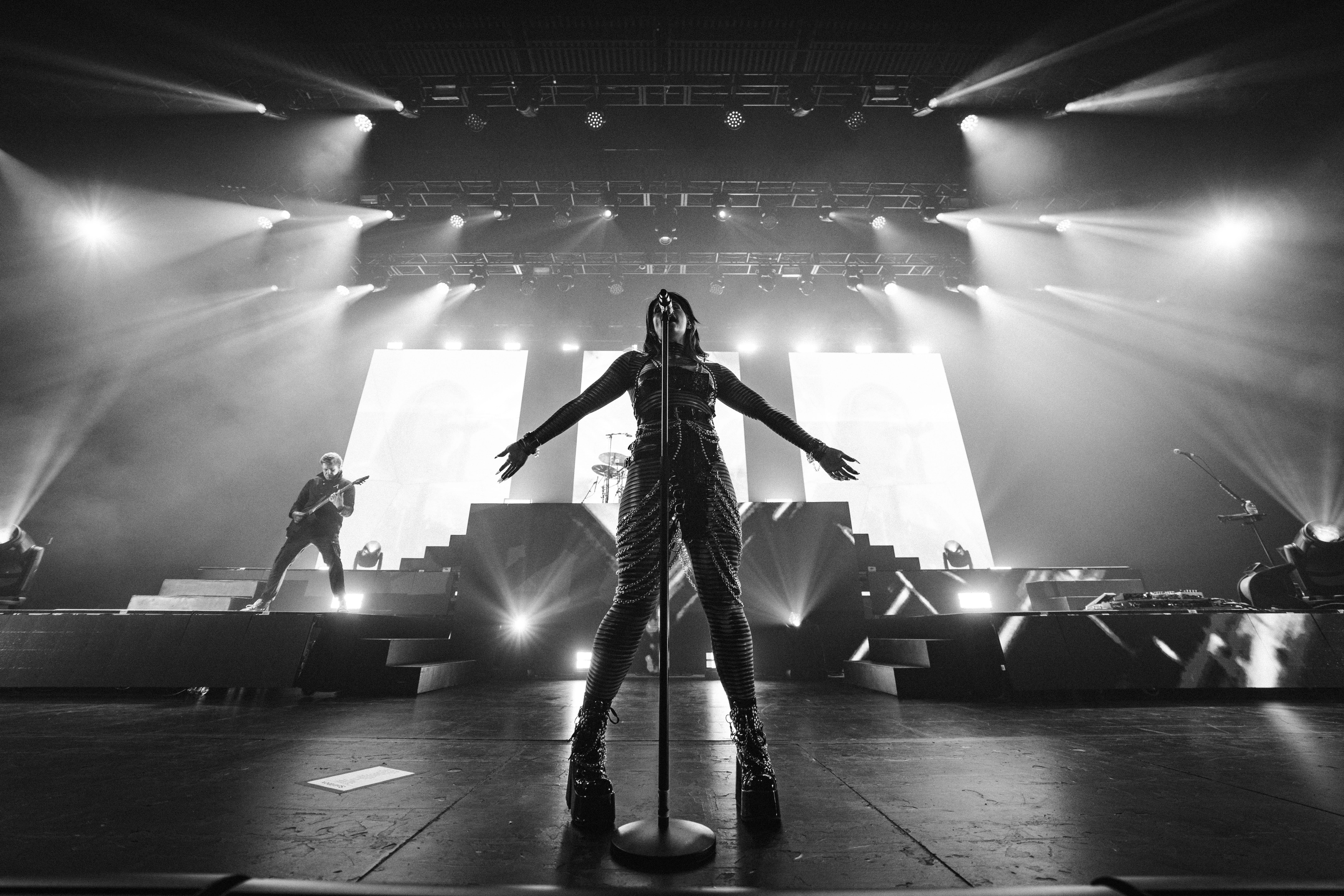 Singer performing on a brightly lit stage