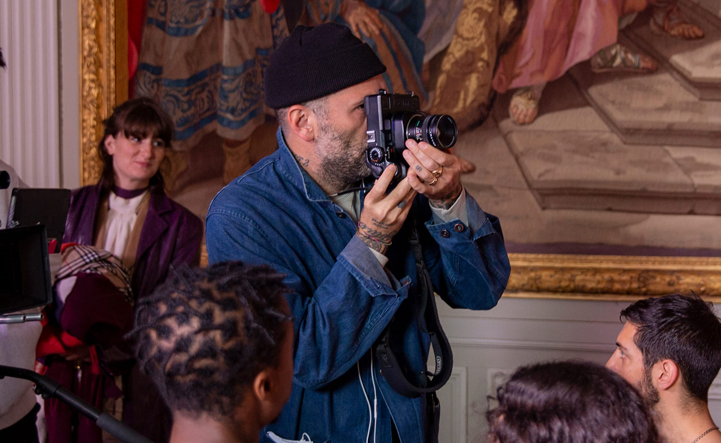 Photographer taking a picture indoors