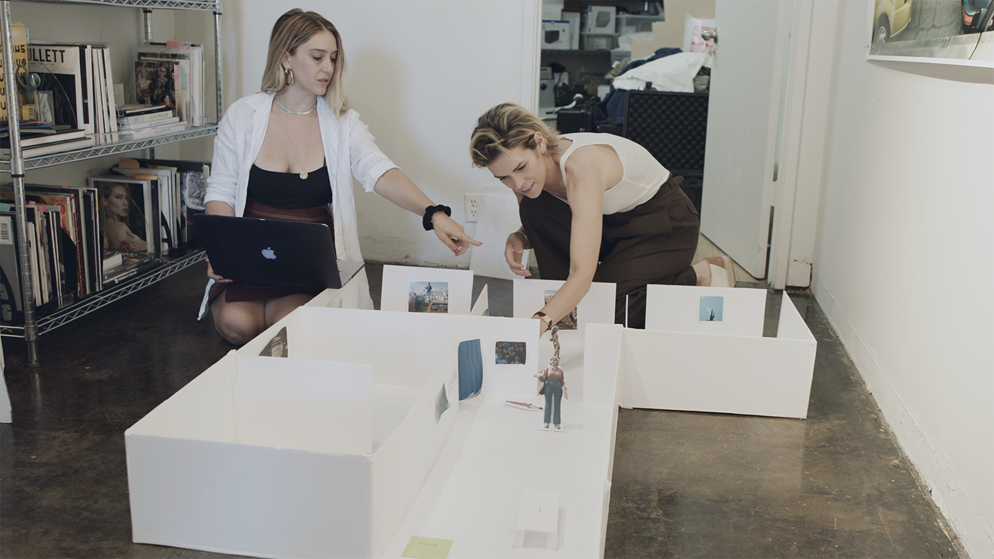Two women reviewing a room model
