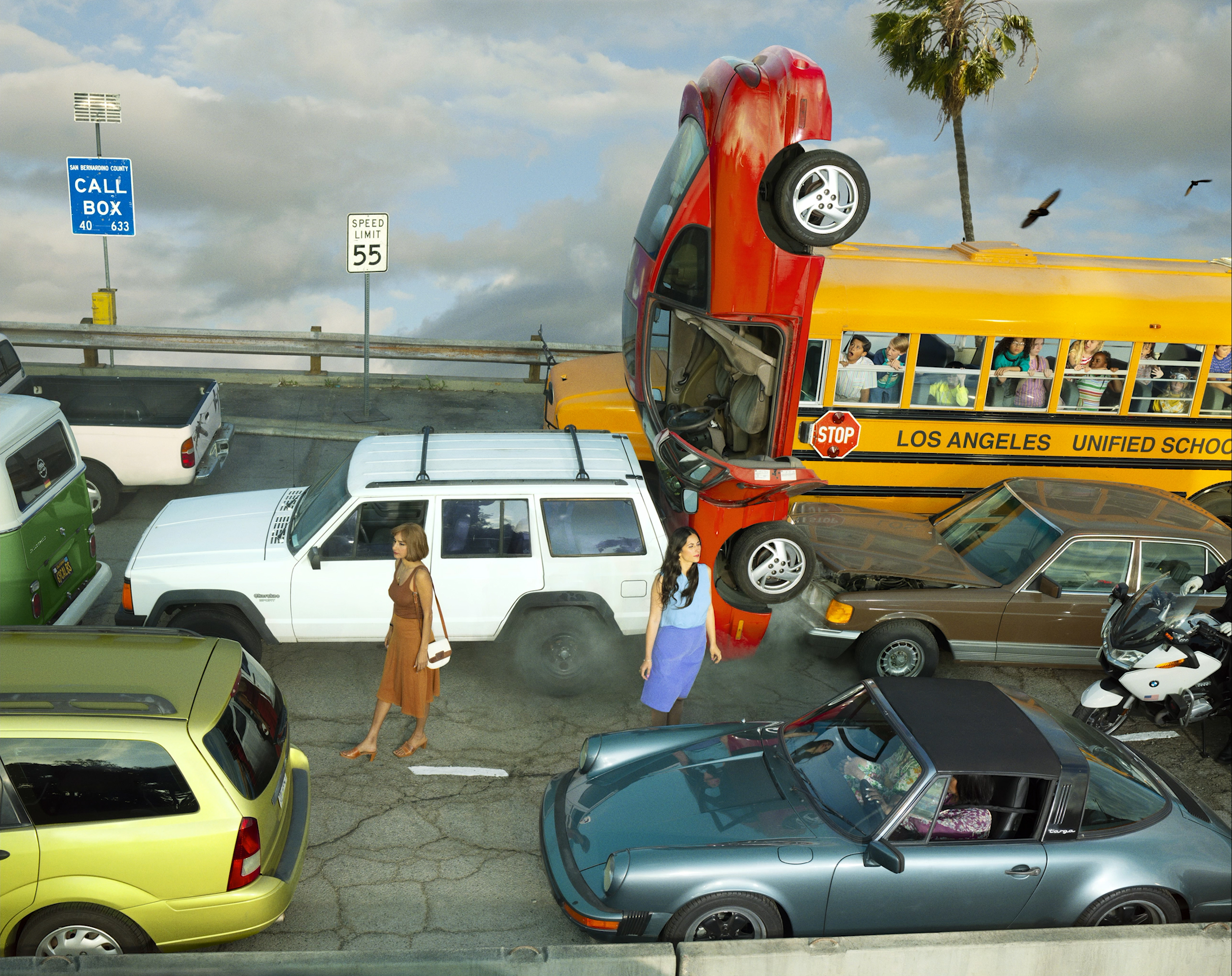 Car flipped onto school bus in traffic