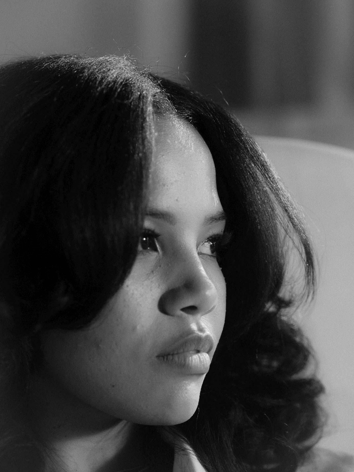Black-and-white close-up portrait of artist Baby Rose looking to the side