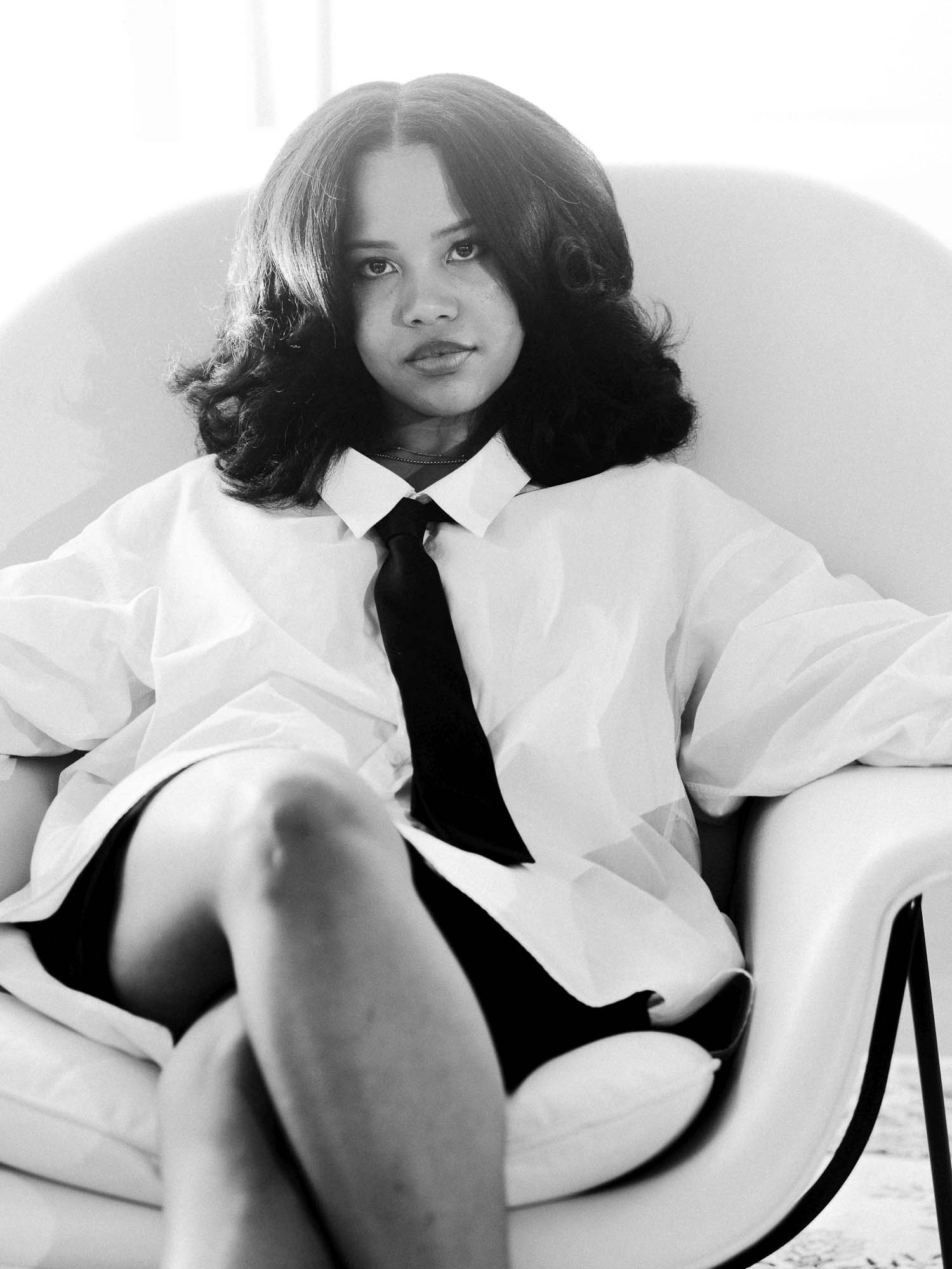 Black-and-white portrait of Baby Rose seated in white shirt and black tie