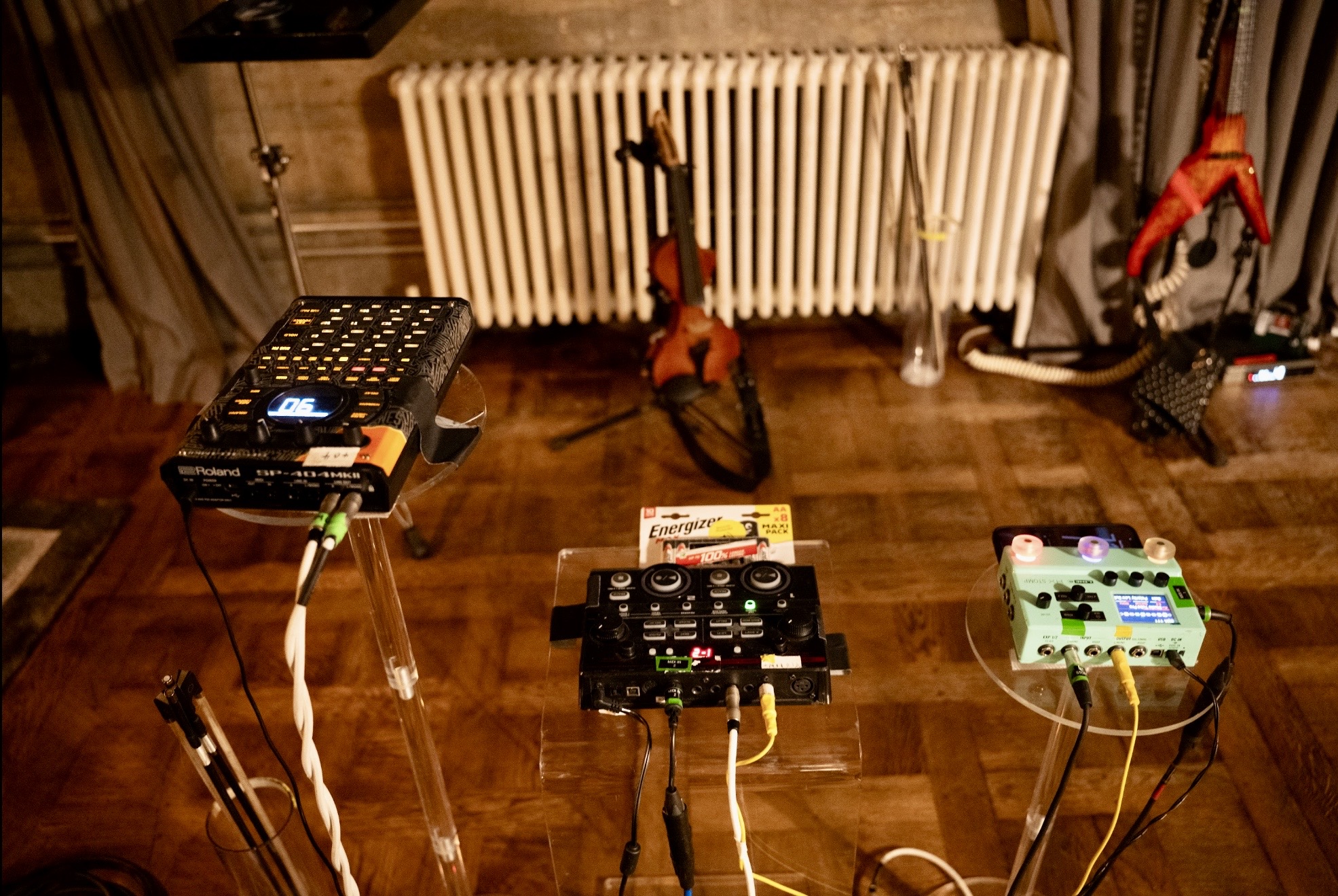 Music production equipment and audio controllers arranged on stands in studio