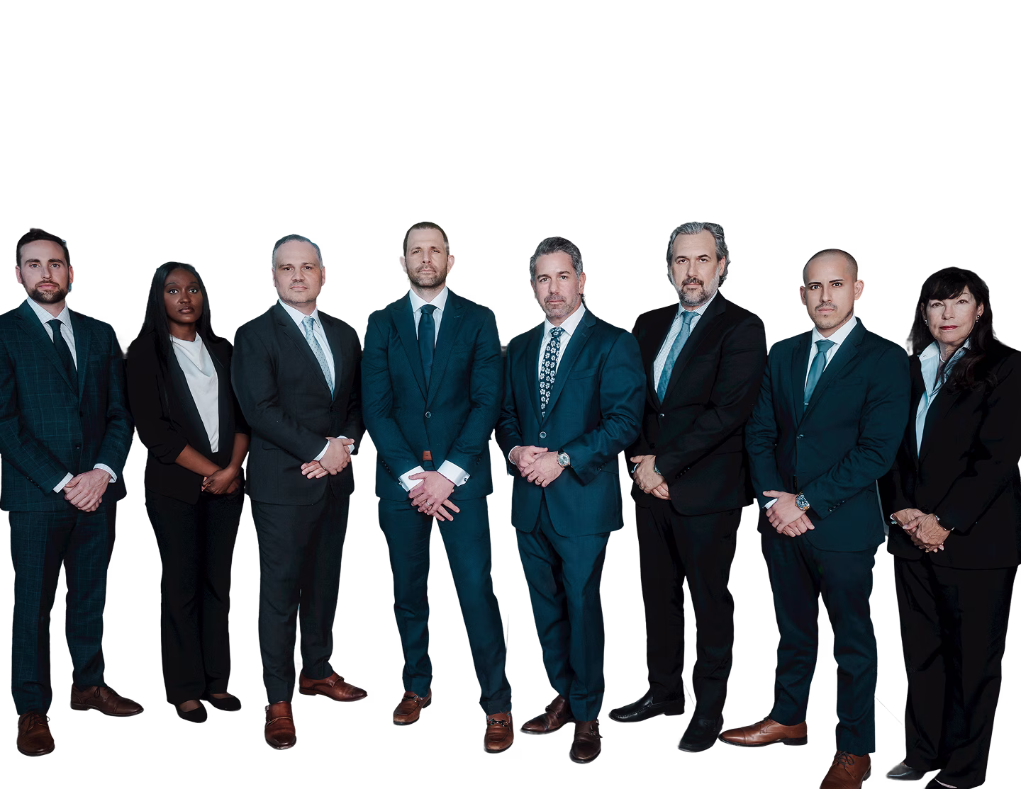 Group of eight professionally dressed diverse business people standing and posing against a black background.