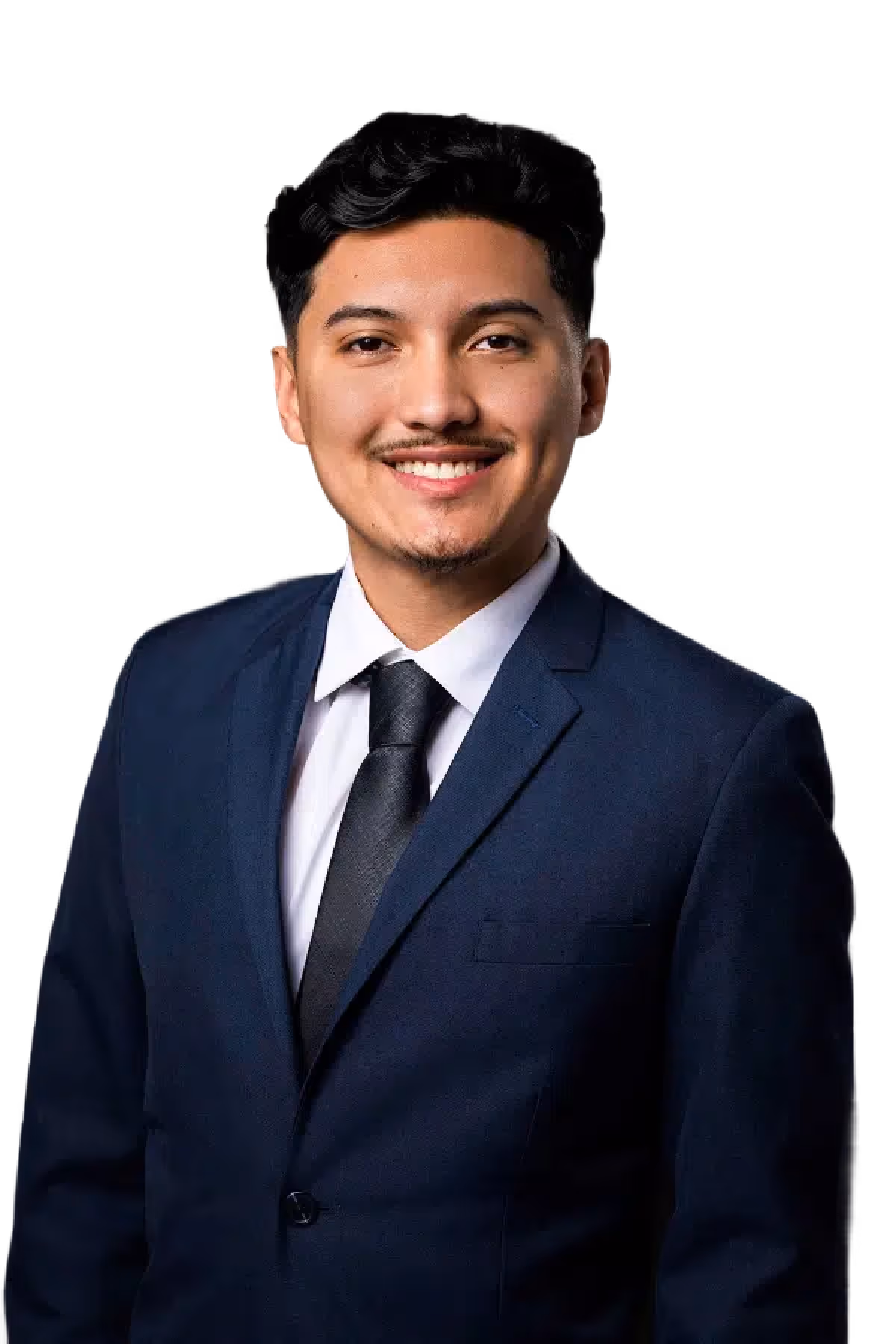 Smiling young man with dark hair wearing a navy blue suit, white shirt, and black tie against a black background.