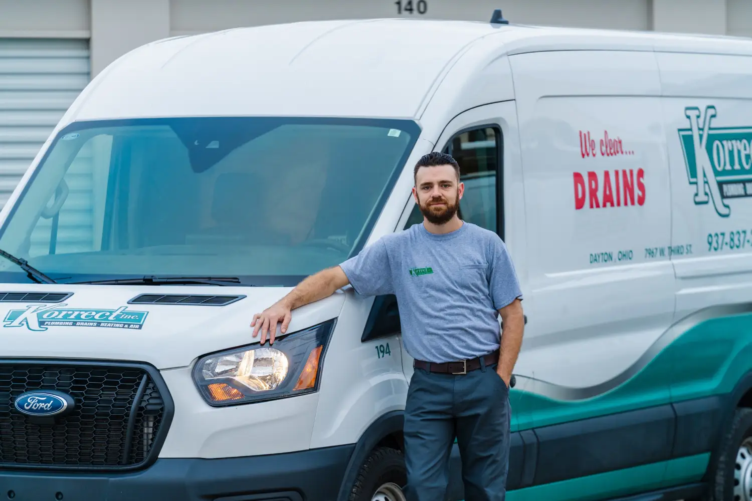 Korrect drain technician beside a 'We clean DRAINS' service van in Dayton, Ohio