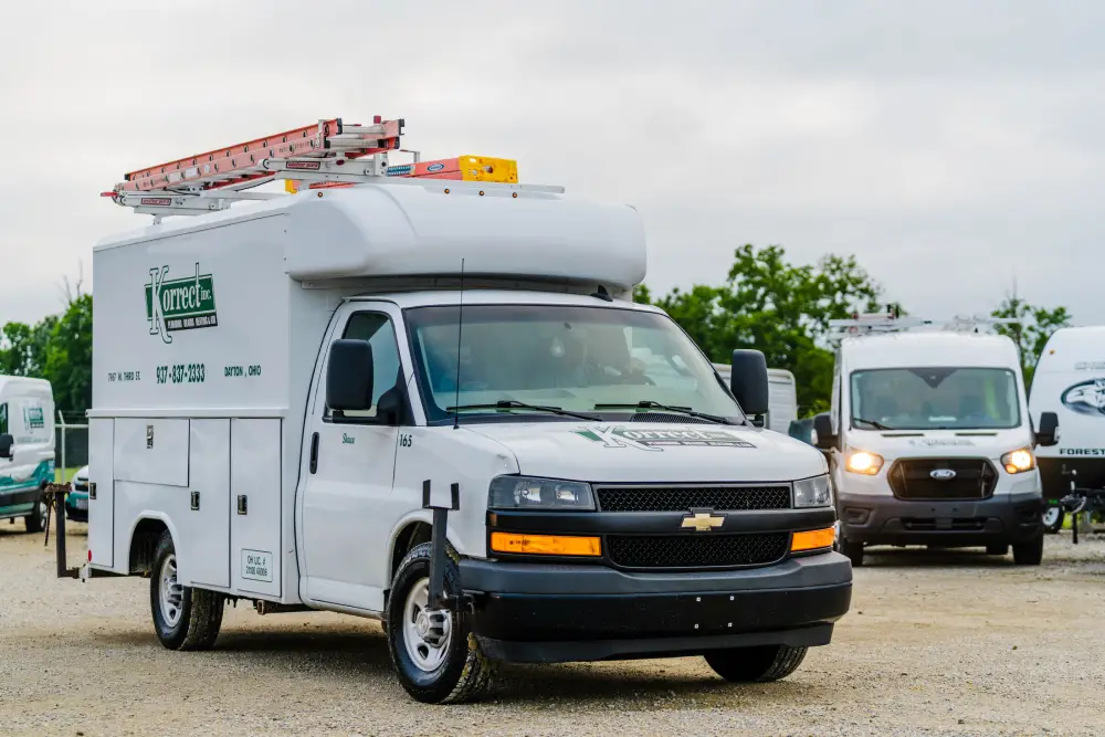 Korrect Chevrolet service truck with a ladder rack parked with the van fleet in Dayton