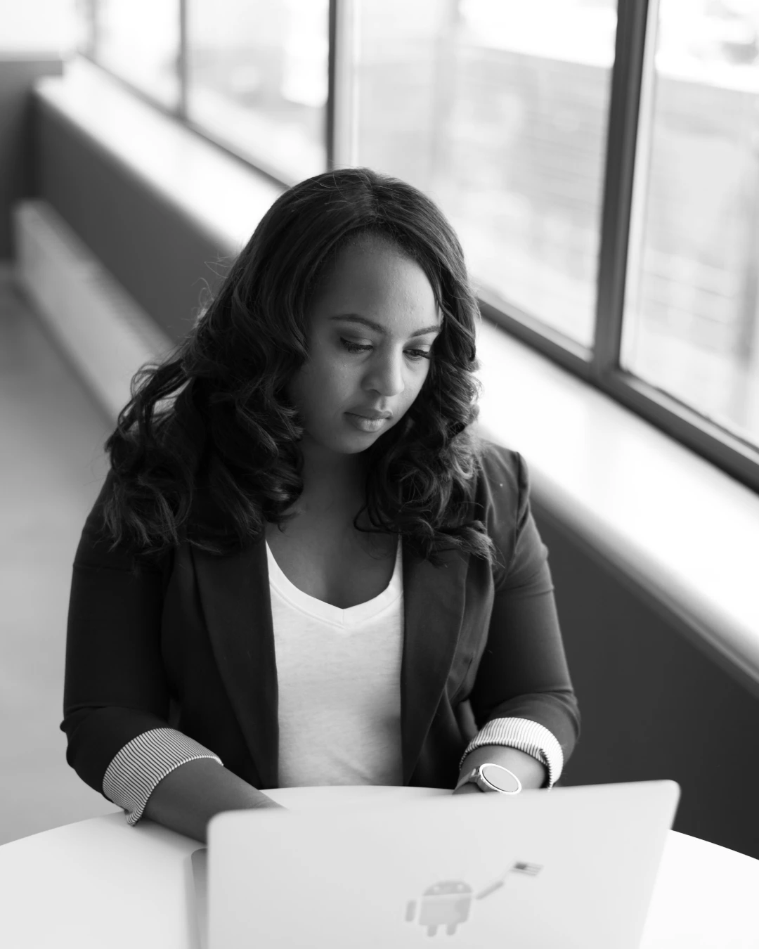 Marketing Manager working on a laptop at a desk, planning marketing strategy and business growth.