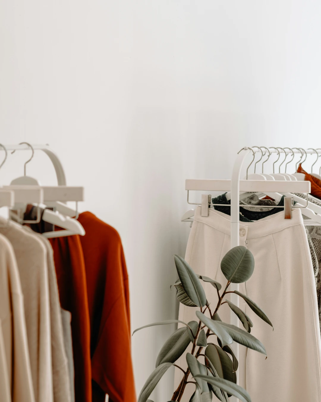 Clothing displayed on racks in a fashion retail store, representing ecommerce product inventory and online store management.