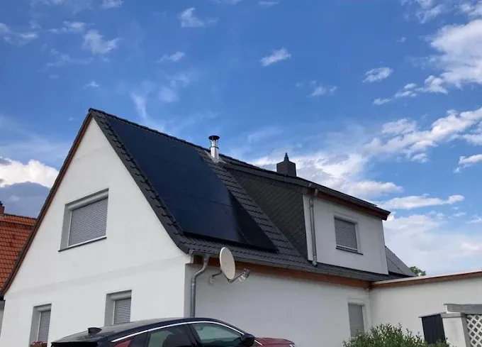 Two women practicing yoga on mats by a pool, one in child's pose and the other in upward-facing dog pose.