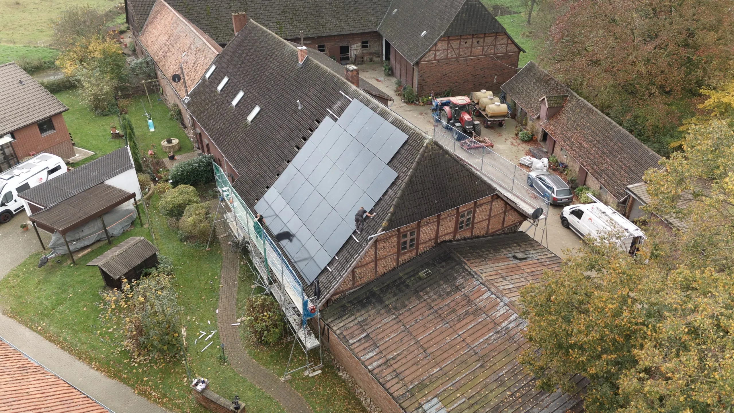 Five young adults sitting at a table enjoying appetizers and drinks, smiling and toasting with wine glasses.