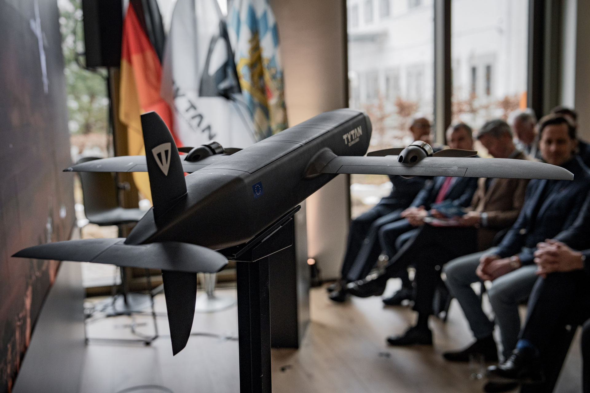 TYTAN Drone in spotlight with audience behind it.