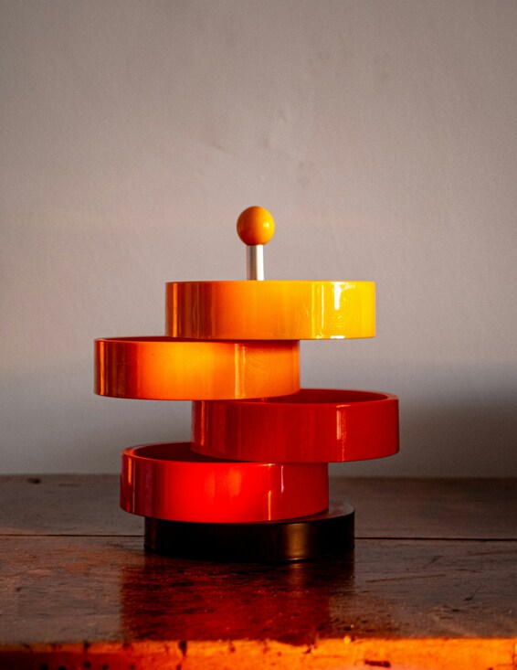 Close-up of a green leaf with water droplets on its surface against a dark blurred background.