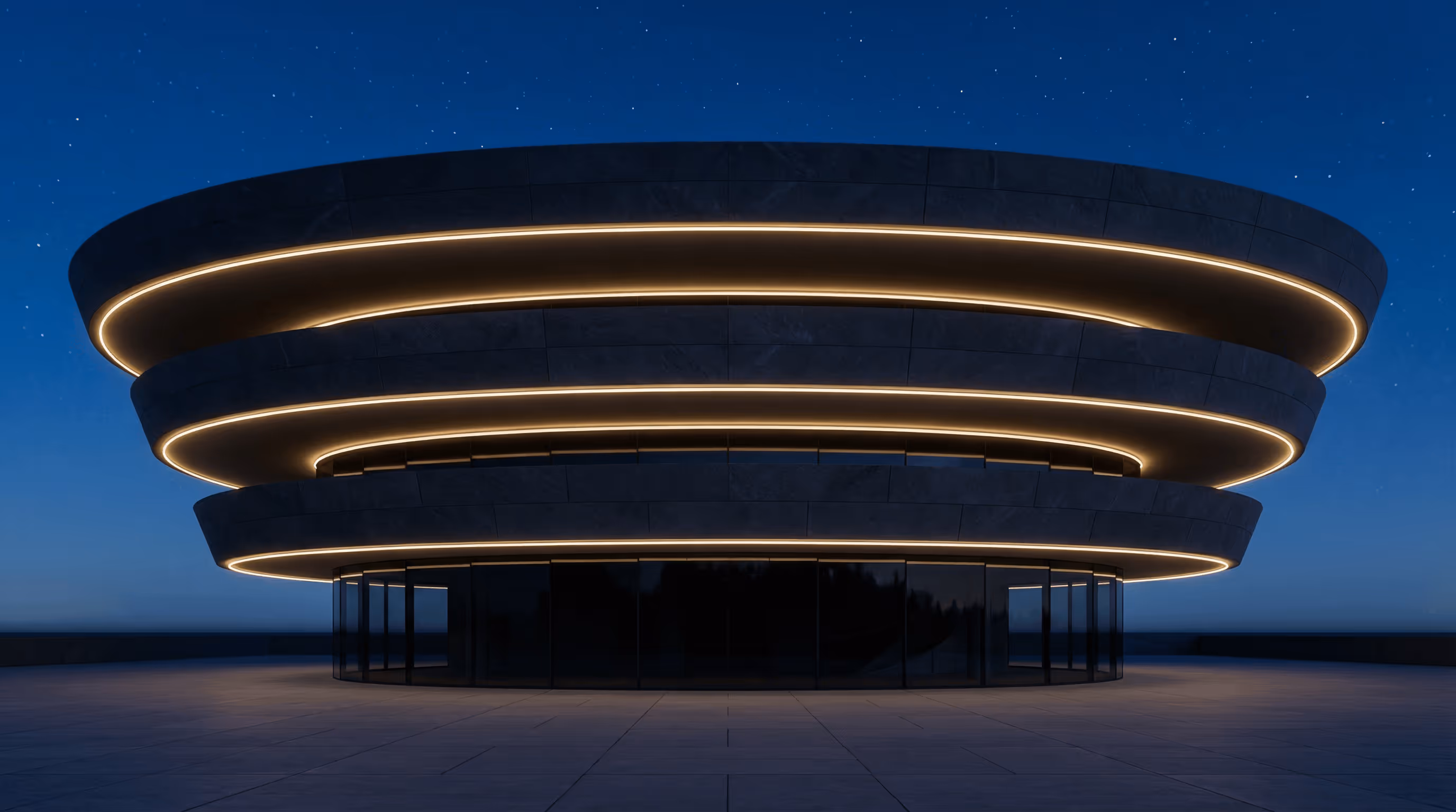Modern circular building with three stacked rings illuminated by warm lights against a starry night sky.