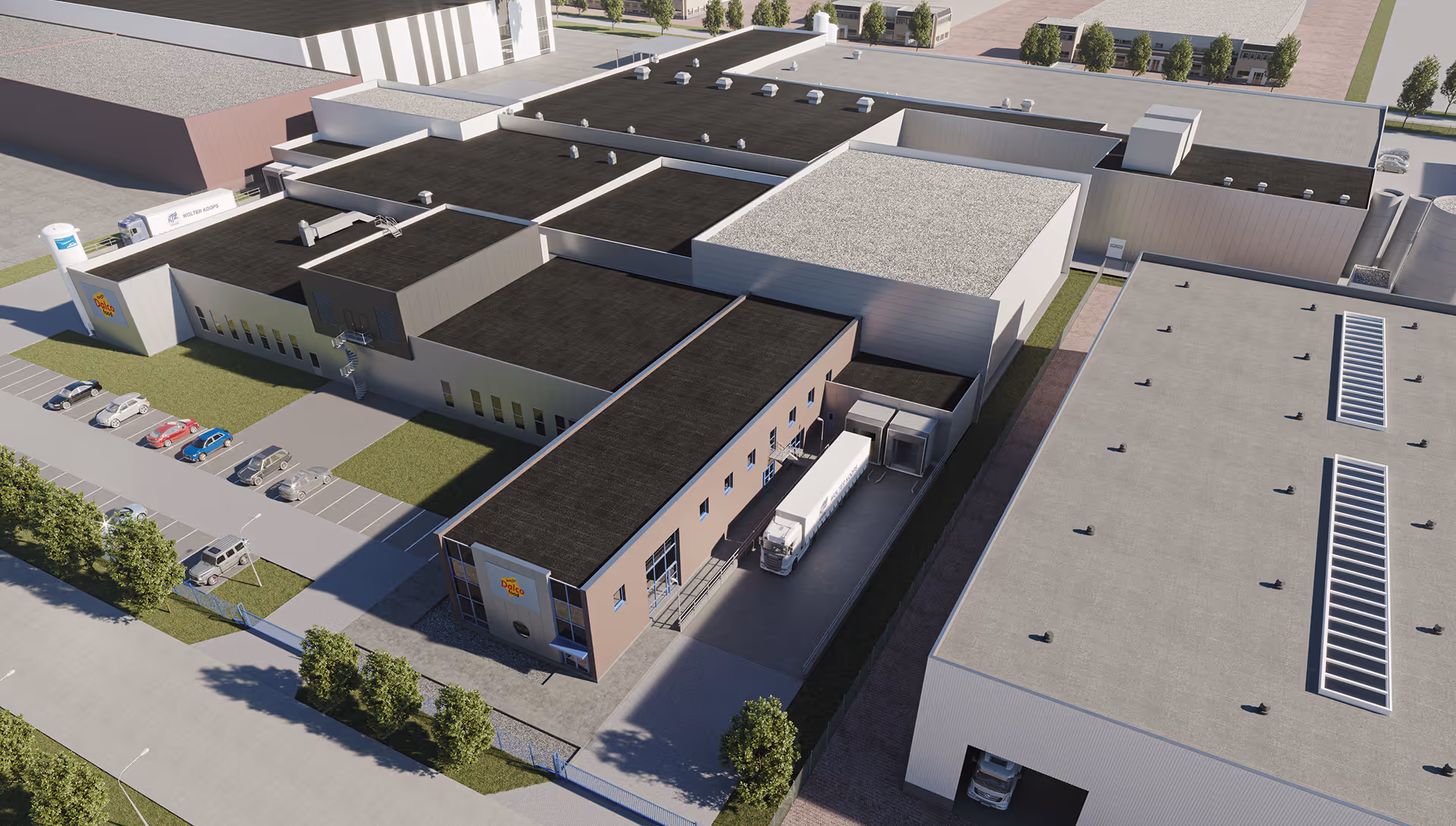 Aerial view of a large industrial warehouse complex with multiple buildings, parking spaces with cars, and a truck docked at a loading bay.