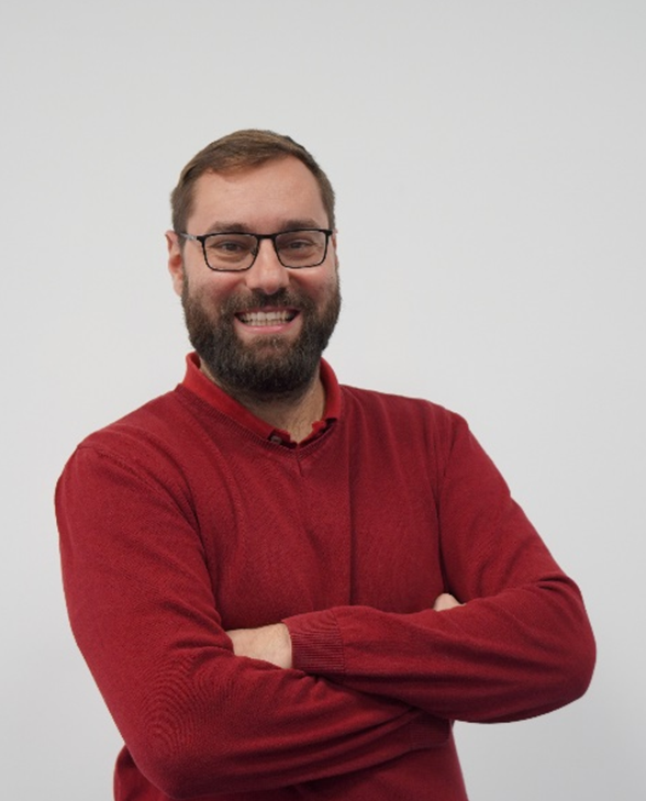 J3 Founder smiling at the camera with his armes crossed wearing a red polo shirt