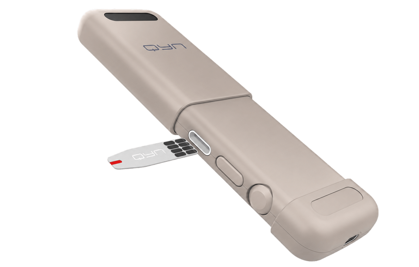 A light beige Qyn medical device with buttons and a test strip being inserted.