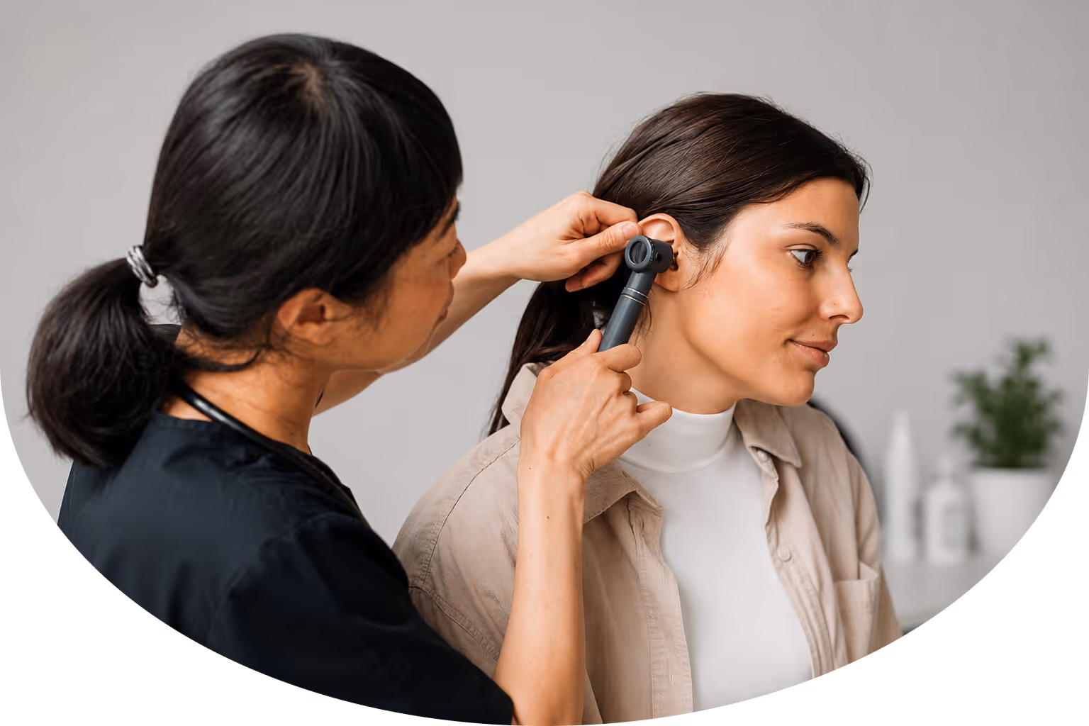 Clinician performing an ear exam during a comprehensive baseline health assessment