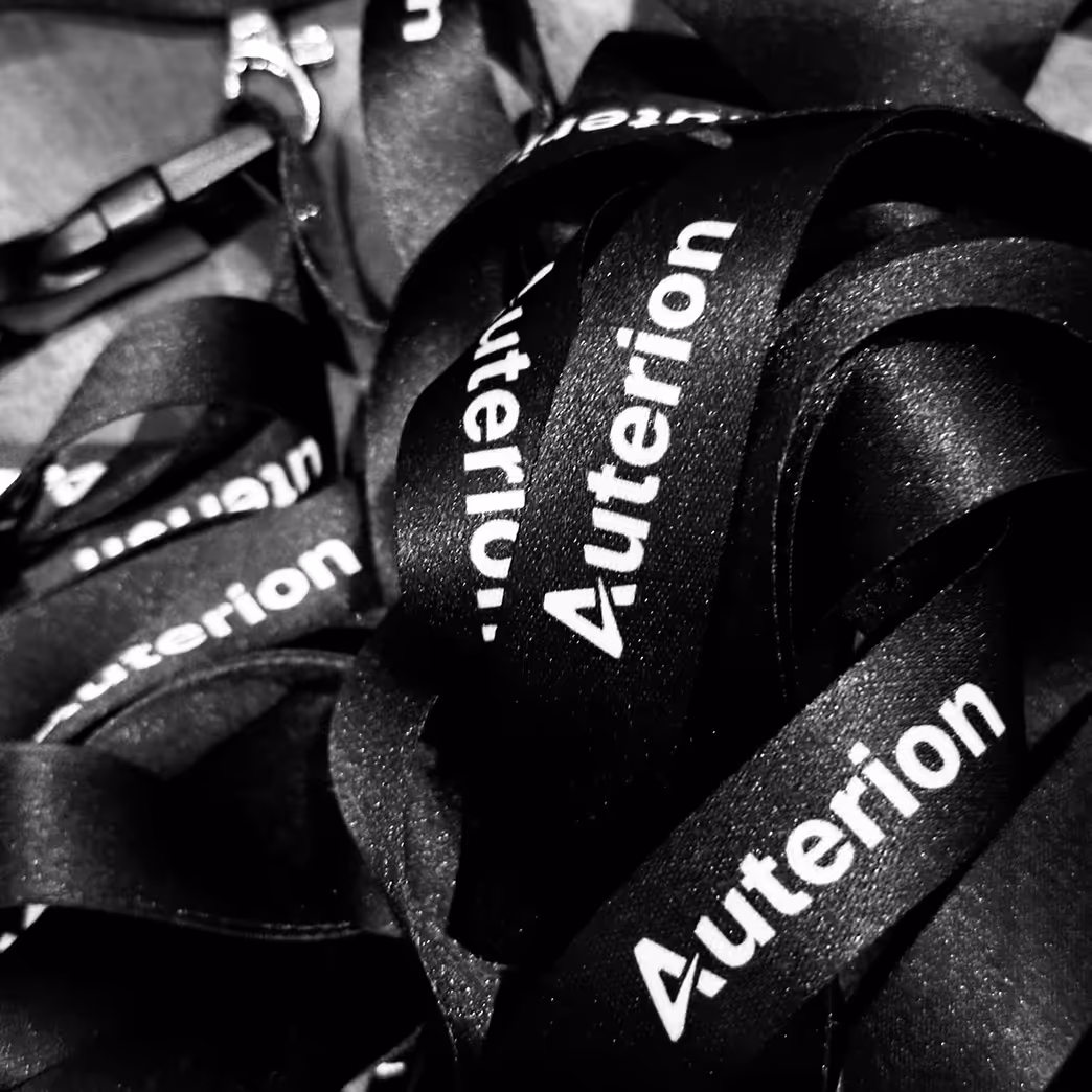 Black lanyards with white Auterion logos printed on them.