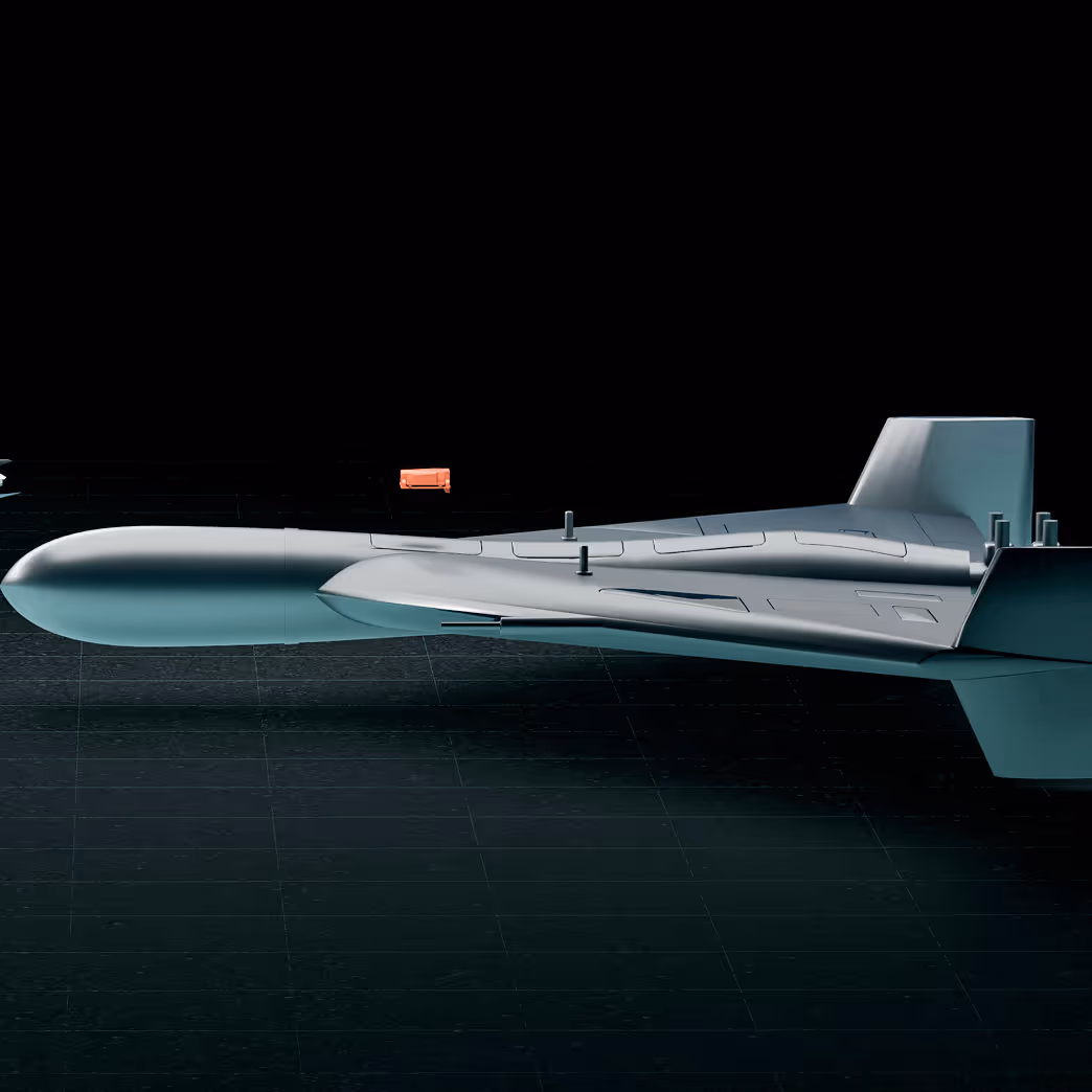 Side view of a sleek, gray futuristic drone with a streamlined body and tail fin against a black background.