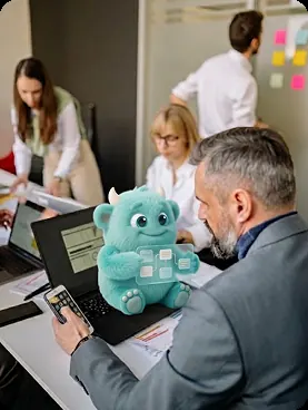 Business team working with AI Monster mascot