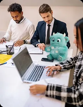 Team in a meeting with AI Monster mascot