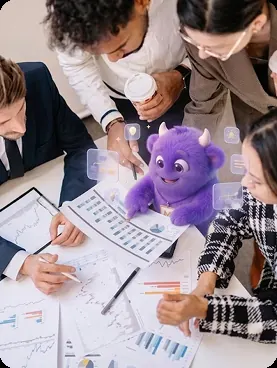 Team reviewing charts with AI Monster mascot
