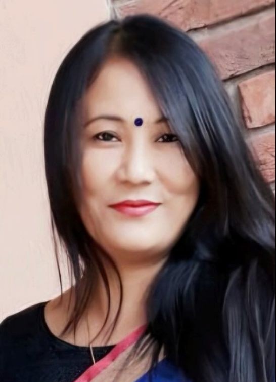 A woman in a white shirt and black pants.