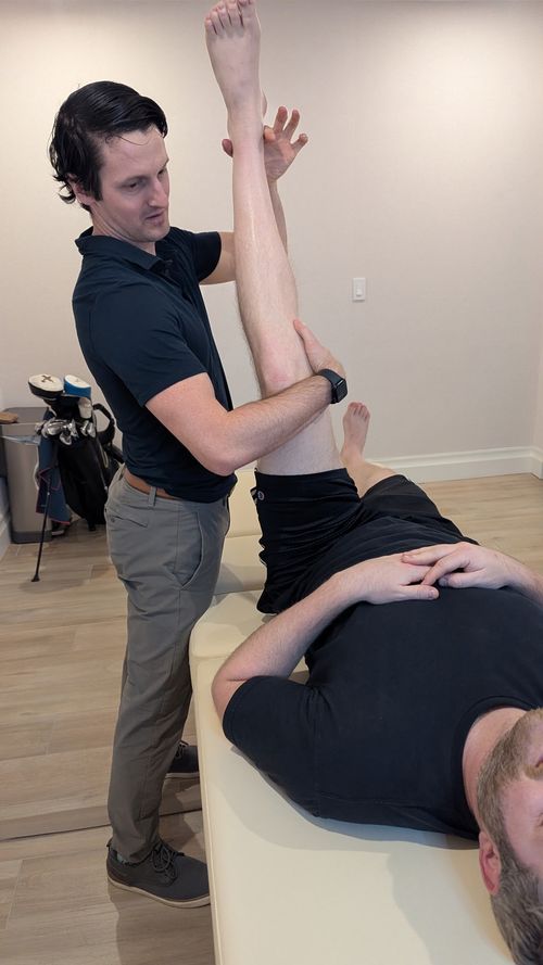 patient performing rehabilitation exercise with therapist providing hands-on guidance