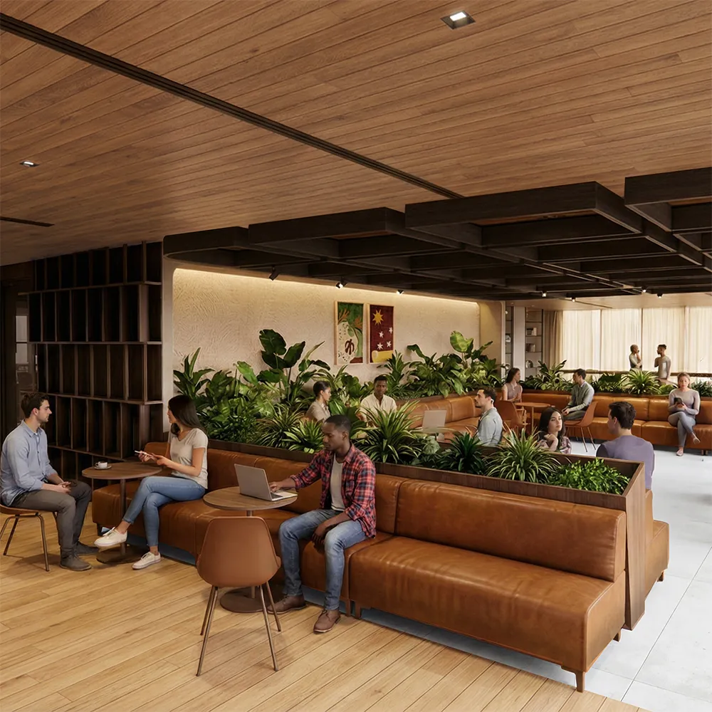 Modern library with brown leather sofas, green plants, and groups of people talking and working.