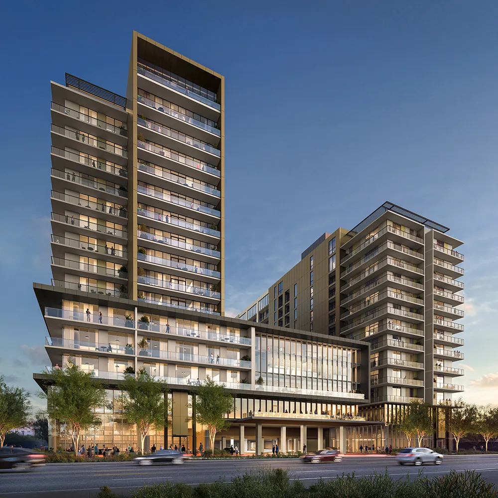The Revelry, a modern multi-story residential building with balconies and people seen inside and outside at dusk.