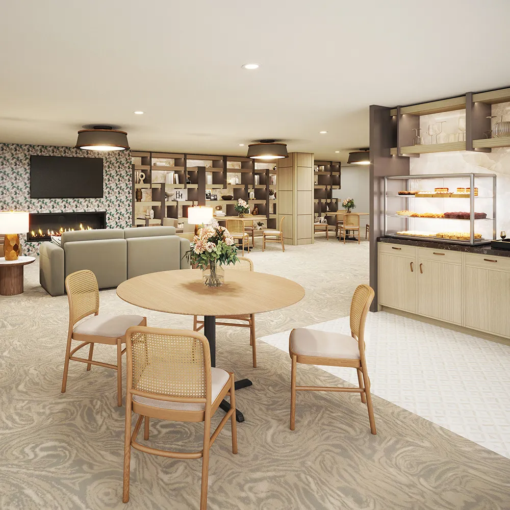 Modern lounge with round wooden table, chairs, fireplace, bookshelf, and bakery display cabinet.