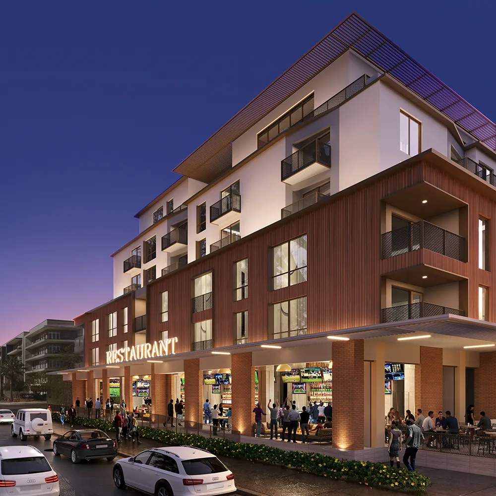 Modern corner restaurant with people outside and multiple balconies on upper floors at dusk.