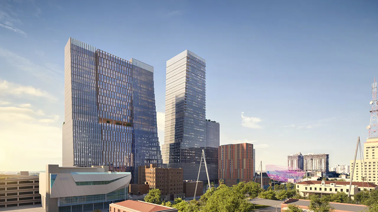 Downtown Phoenix skyline with tall glass buildings and clear blue sky during daytime.