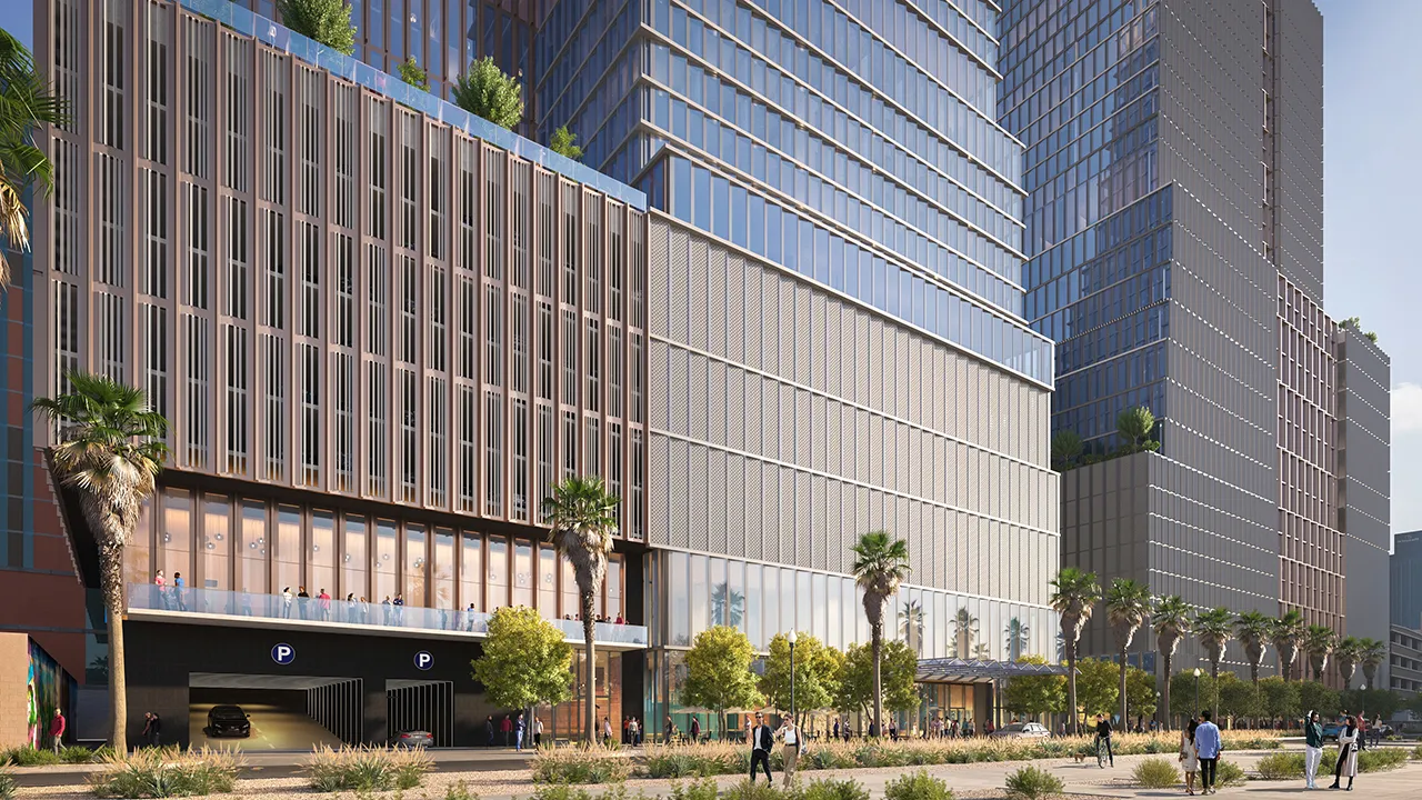 Modern high-rise building with glass facade, palm trees, and people walking along the sidewalk.