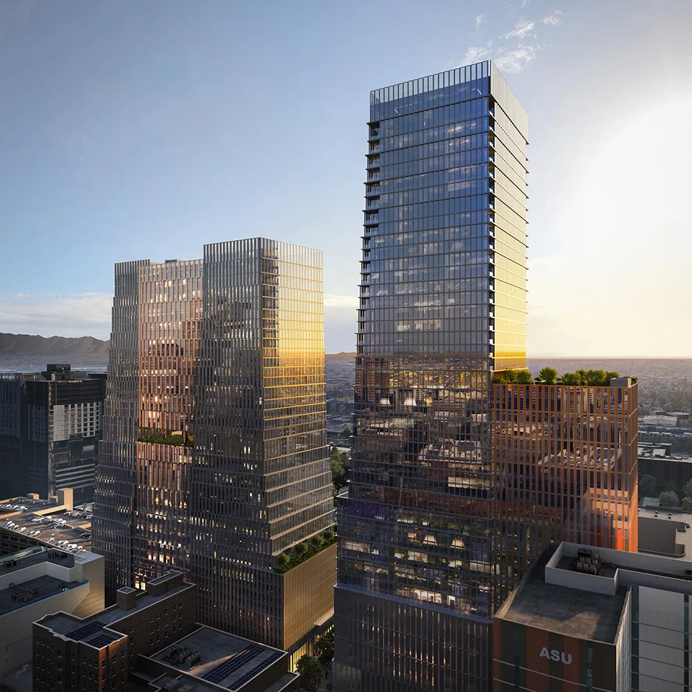 Arro, modern glass skyscrapers reflecting sunset light with mountains in the background.