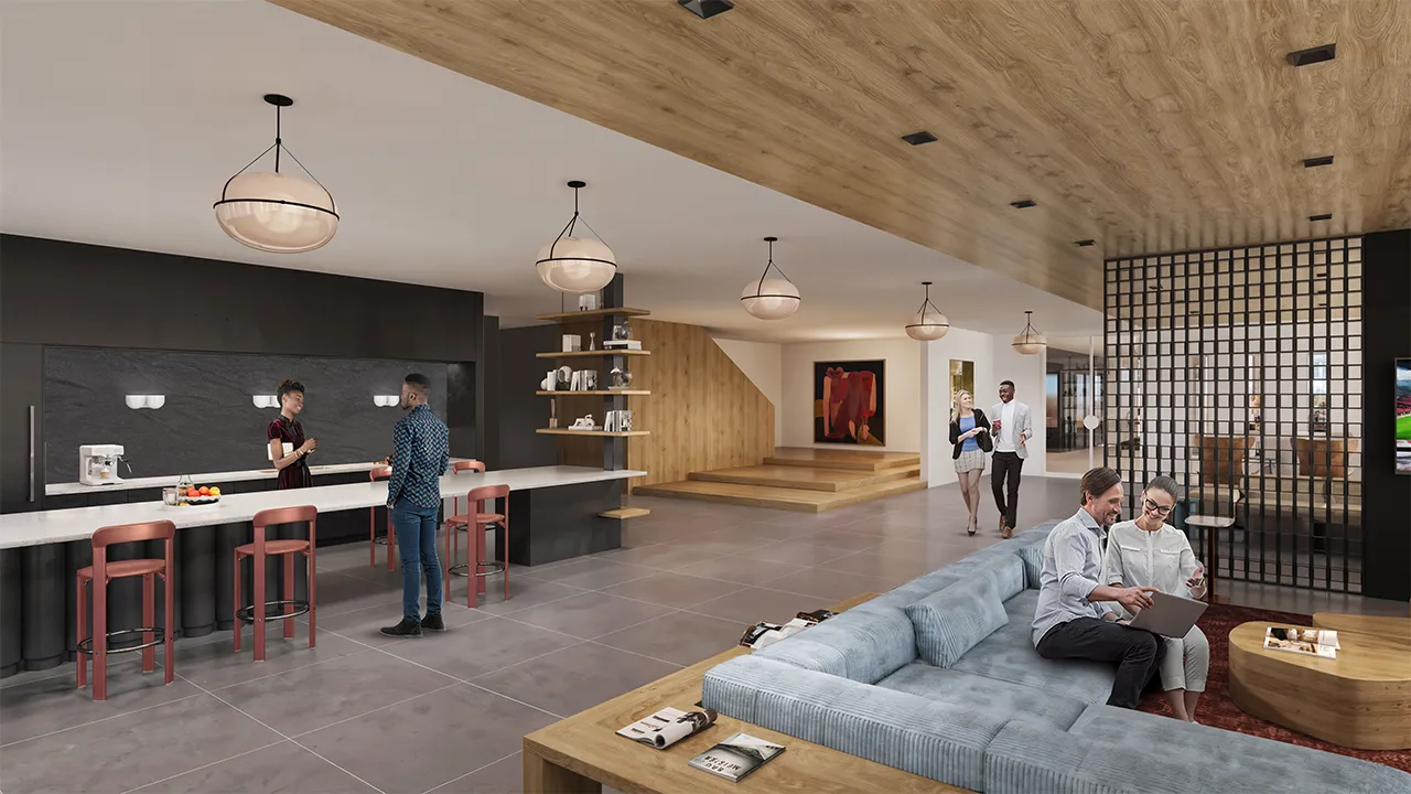 Modern clubhouse interior with two people seated on a couch using a laptop and two others walking and talking.