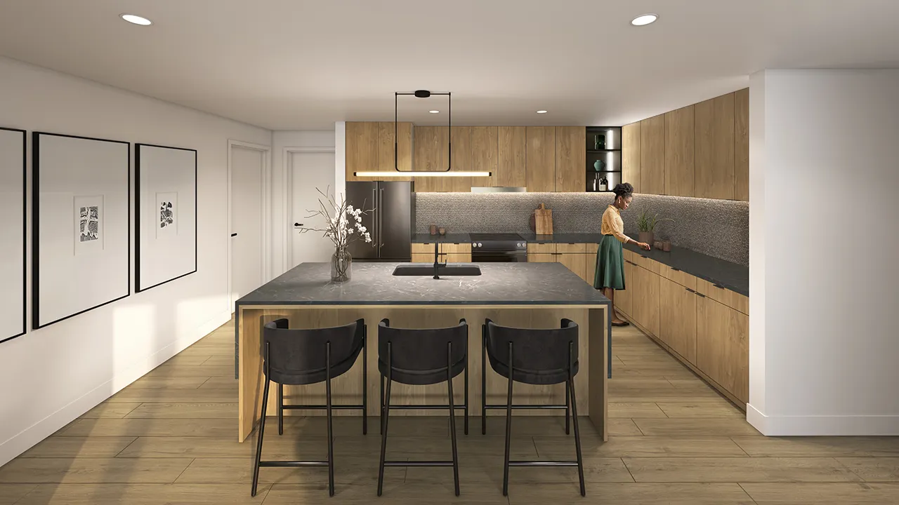 Modern kitchen with wooden cabinets, island with gray countertop, three black stools, and a woman arranging plants.