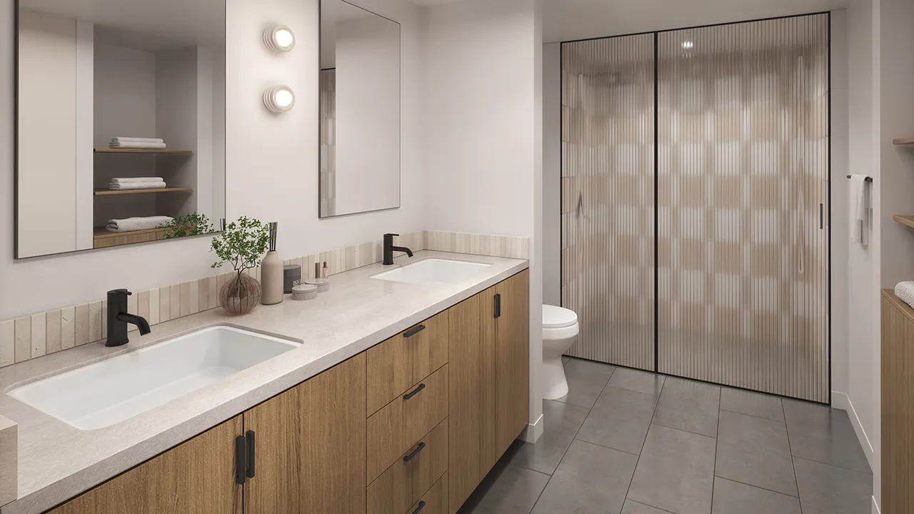 Modern bathroom with double sink vanity, wood cabinets, large mirrors, and frosted glass shower doors.