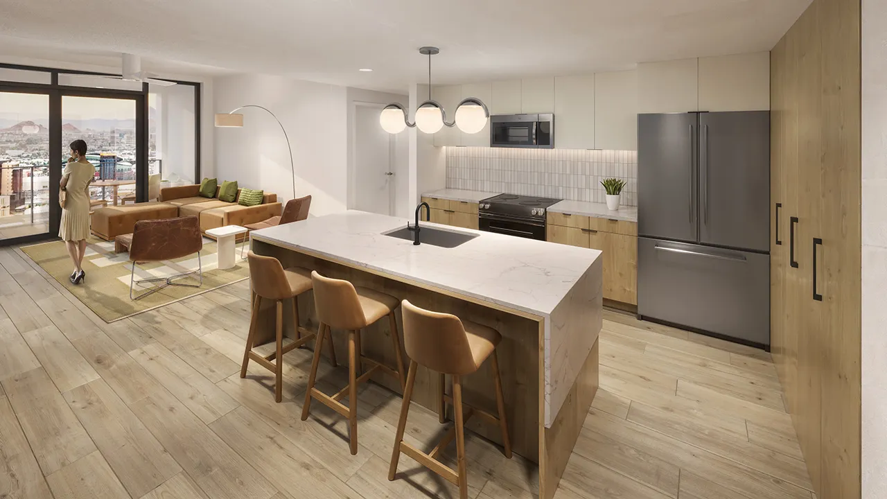 Modern kitchen with marble island, three leather stools, stainless appliances, and wood cabinets.