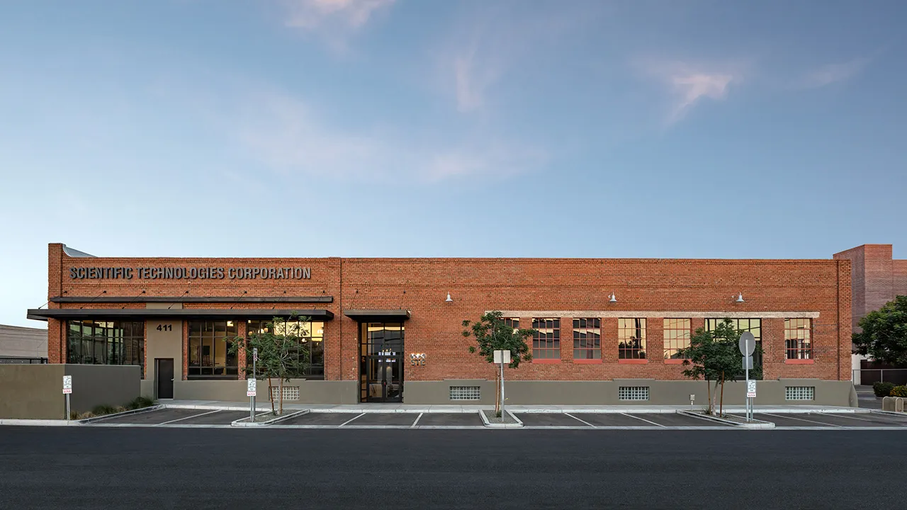 Brick building with large windows labeled 'Scientific Technologies. 