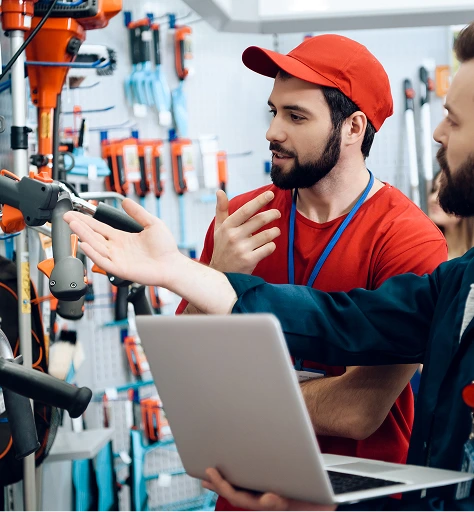 Customer shopping at local hardware store with expert staff assistance