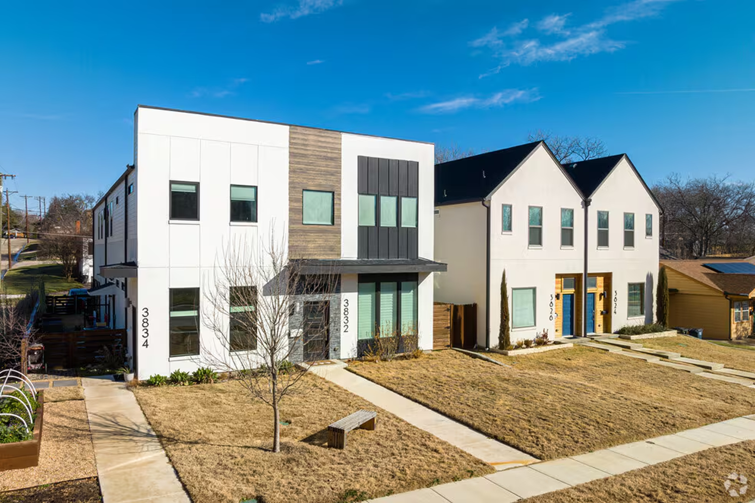 City skyline featuring tall modern skyscrapers at sunset, with the Burj Khalifa prominently in the center.