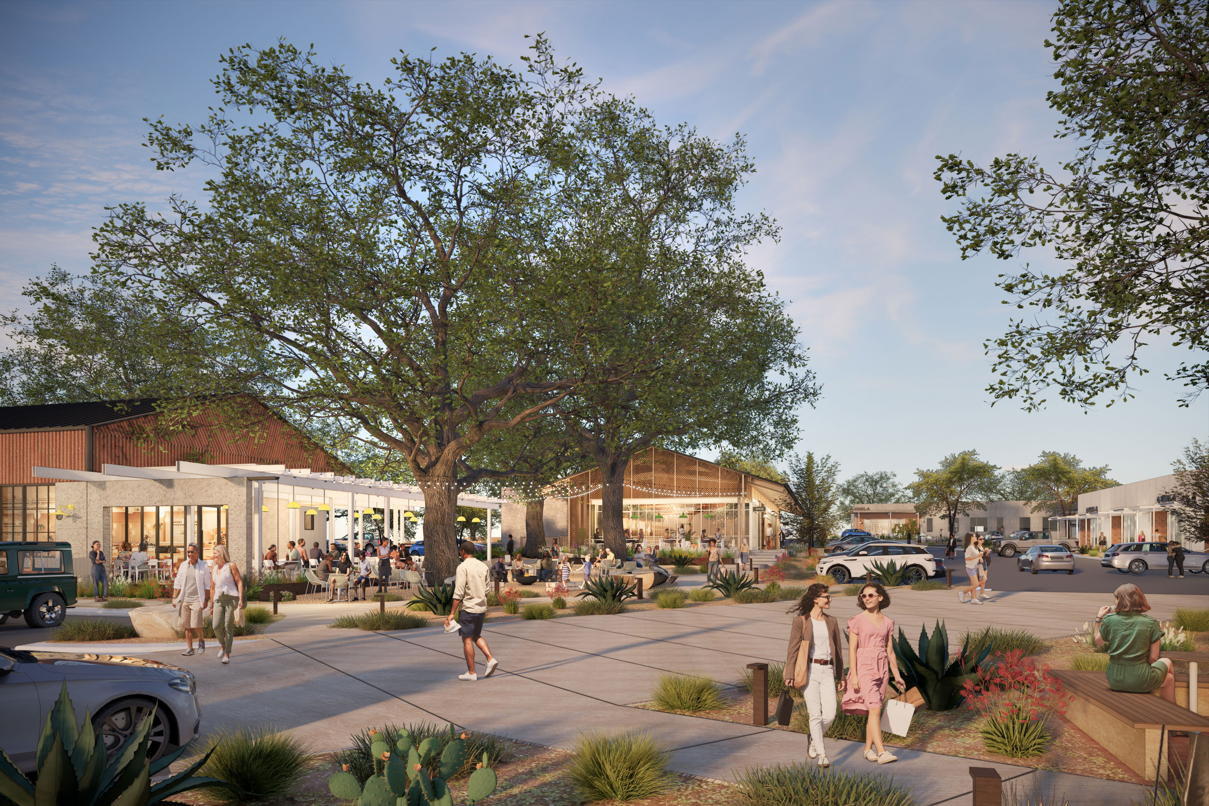 Outdoor plaza with people walking, sitting, and dining among large trees and modern buildings under a blue sky.