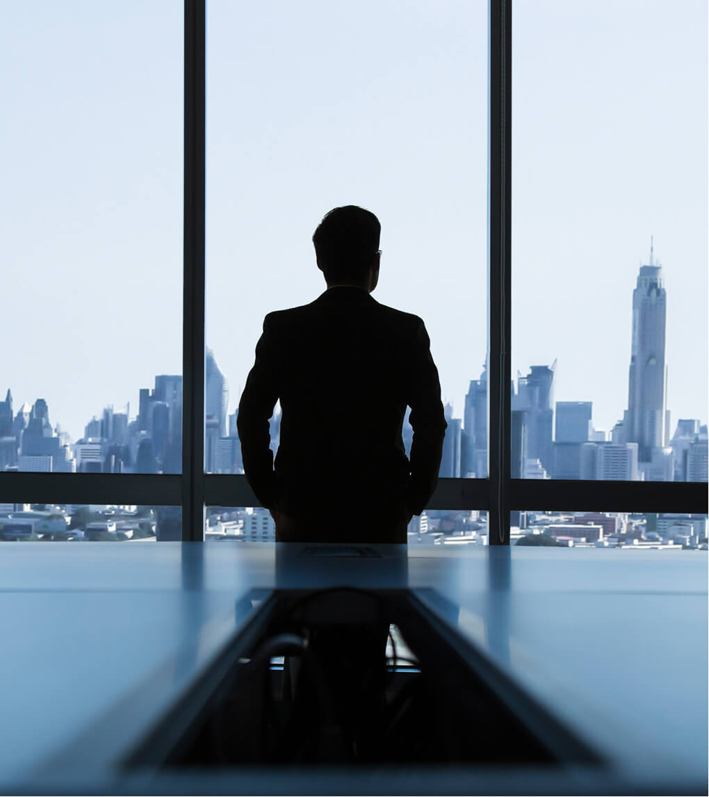 Person sitting in front of office windows