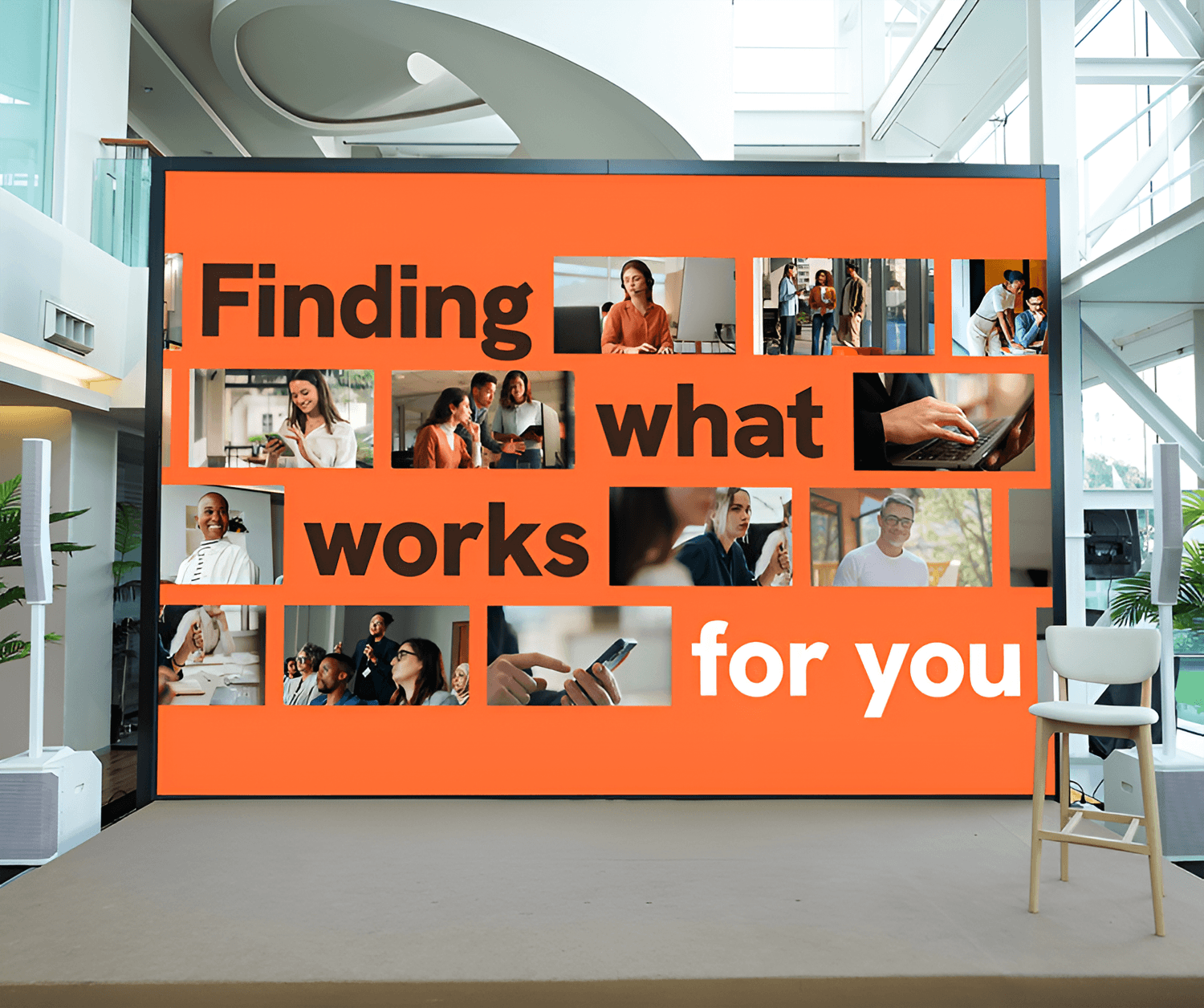 A large orange display in a modern office reads "Finding what works for you," surrounded by a collage of photos showing diverse professionals working and collaborating.