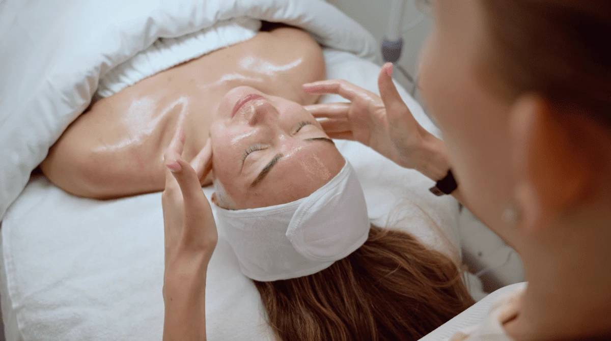 A client receiving a relaxing, hydrating custom facial massage from an expert esthetician at City Glow beauty salon in Brickell, Miami.
