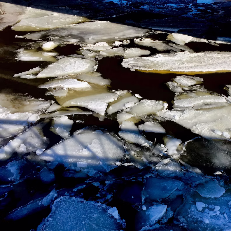 The cover for Conyer Clayton's EP Futher Behind You, which shows ice breaking up in shadow.