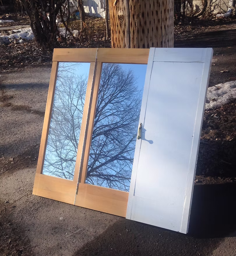 The cover for the single, Sound Carries, which shows trees reflected in a mirror on the street.